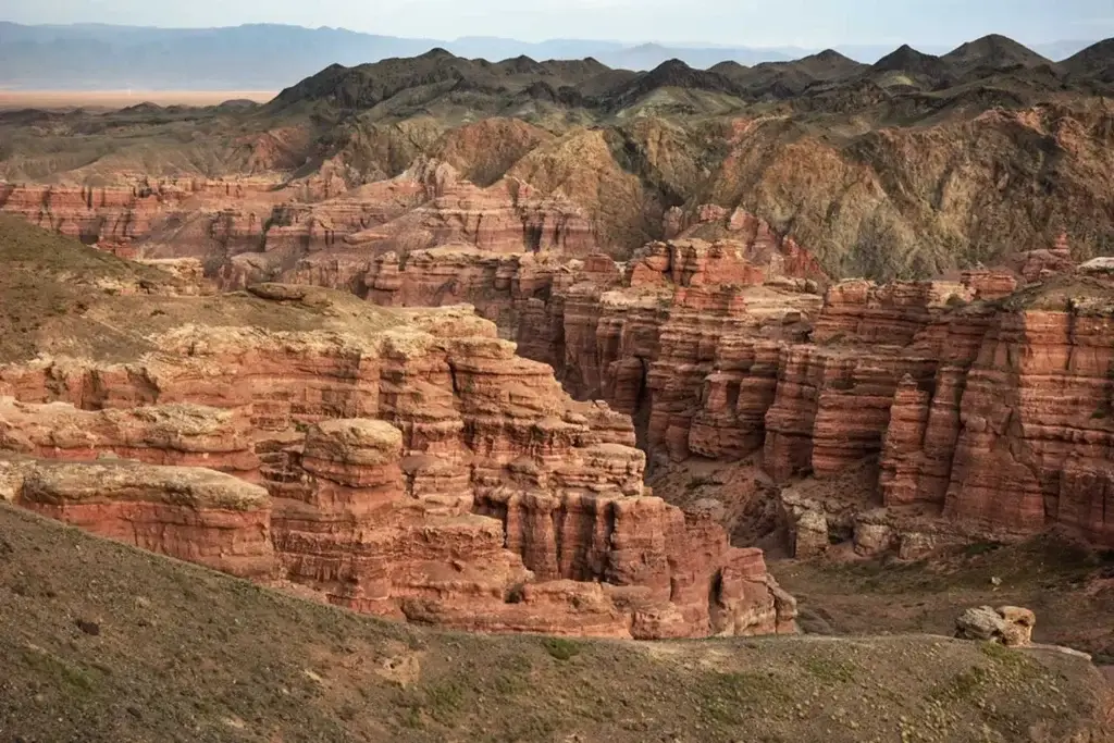 Charyn Canyon in Kazakhstan with layered red rock formations and deep gorges
