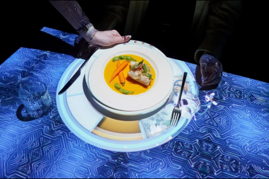 Dish served on an interactive table with digital projection and table setting during a gastronomic dining experience