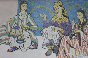 Colorful mosaic wall panel depicting three women in traditional Uzbek dress performing a folk dance against a blue patterned background
