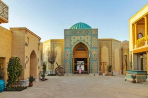 Courtyard with traditional Middle Eastern architecture, featuring mosaic tilework and a domed structure