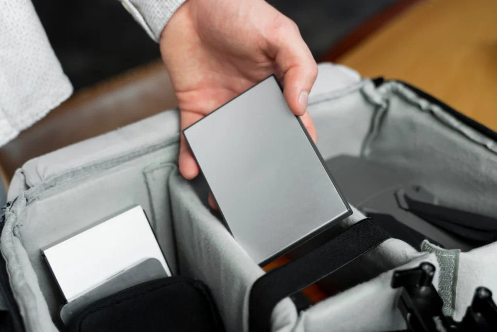 Close-up of a hand holding an SSD device