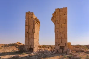 Ruins of two tall stone columns of the Beluli caravanserai on the Ustyurt Plateau in Uzbekistan