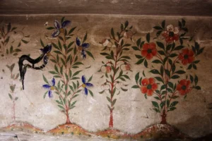 Fragments of decorative wall paintings in an old house